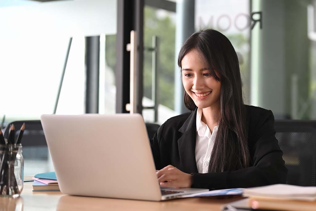 IT specialist smiling while working on computer