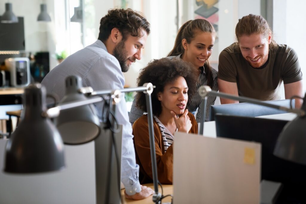 group of coworkers working on computer that has microsoft 365 security tools installed