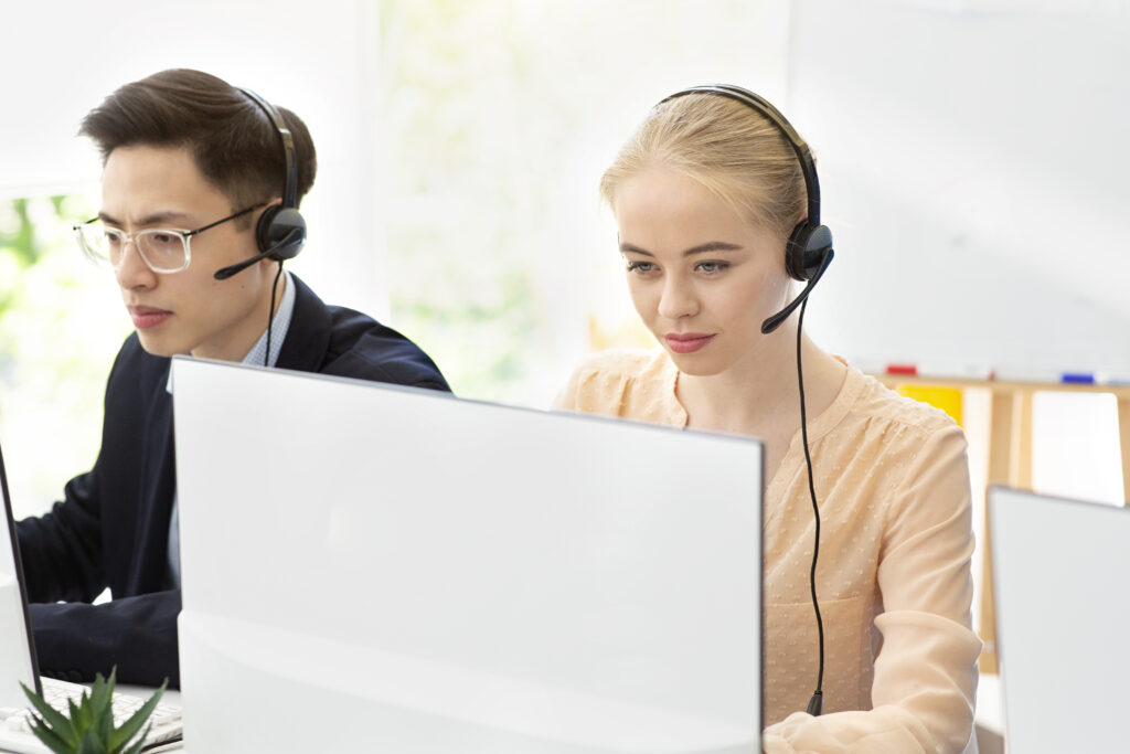 Young tech support services operators at work in contemporary call centre