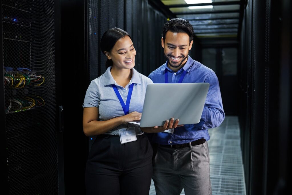 two managed it support services professionals working in server room