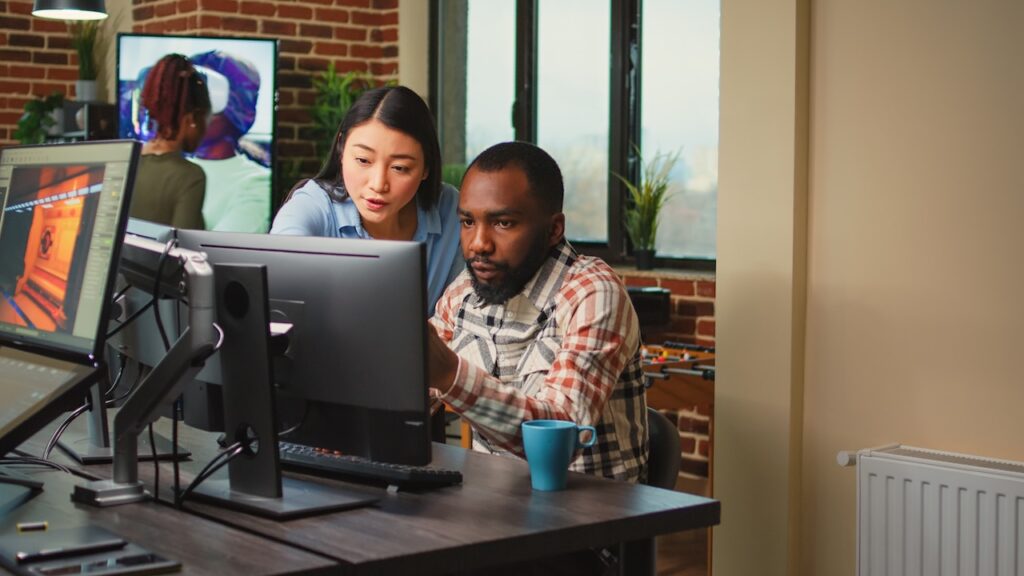 coworkers in office working on computer for project tasks
